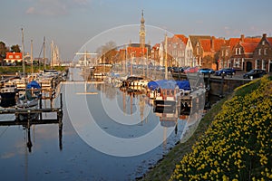 The marina harbor and historic buildings with the clock tower of the Stadhuis town hall in Veere