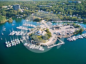 a marina is located on the shore of lake ontario with many boats docked in it