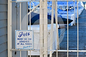 Marina with a Pets on Leashes sign on gate