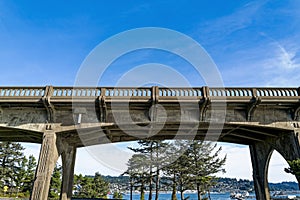 The marina is visible below a section of the Yaquina Bay Bridge at Newport, Oregon, USA