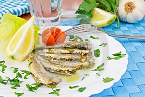 Marinated anchovies in the dish with lemon