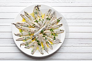 Marinated anchovies with olive oil and parsley