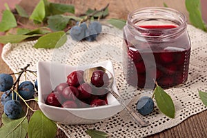 Marinated berries of blackthorn in square bowl