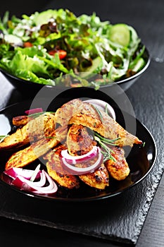 Marinated chicken breast stripes with salad