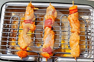 Marinated chicken brochette on electric barbecue