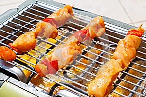 Marinated chicken brochette on electric barbecue