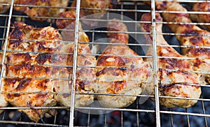 Marinated chicken legs on the grill in the smoke. A picnic, tasty food. BBQ