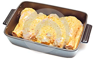Marinated chicken legs in a tray