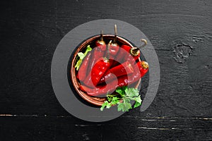 Marinated chili pepper in a bowl. Top view.