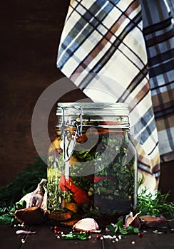 Marinated eggplant with onions and peppers in a bowl, vintage wooden background, selective focus