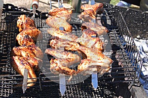 Marinated, fried with a crispy golden crust fried chicken wings on the grill.