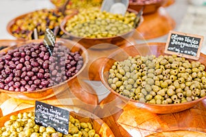 Marinated garlic and olives on provencal street market in Provence, France. Selling and buying.