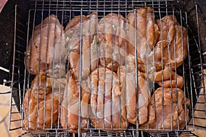 Marinated grilled chicken on the flaming grill.