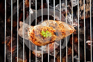 Marinated grilled chicken on the flaming grill