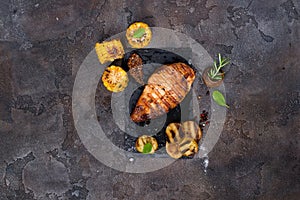 Marinated grilled healthy chicken breasts cooked on a summer BBQ and served with fresh herbs, potatoes and corn