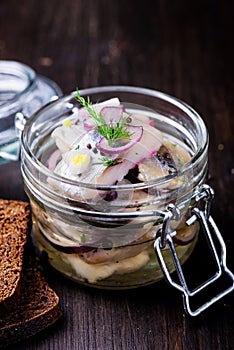 Marinated herring in a jar with spices