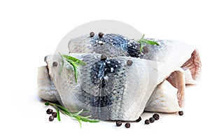 Marinated herring rolls with herbs isolated on white