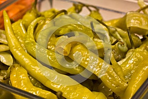 Marinated hot peppers in a glass dish