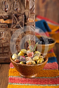 Marinated Olives in bowls with moroccan ornament on wood