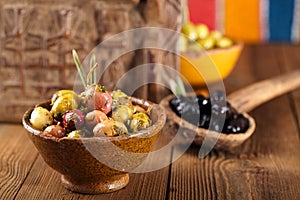 Marinated Olives in bowls with moroccan ornament on wood