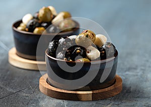 Marinated olives with herbs and garlic in bowl