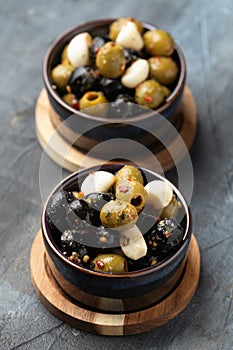 Marinated olives with herbs and garlic in bowl