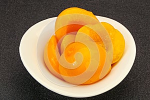 Marinated peaches fruit in the bowl