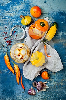 Marinated pickles preserving jars. Homemade yellow vegetables pickles. Fermented food. Top view photo