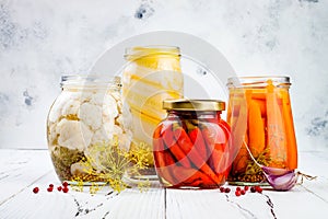 Marinated pickles variety preserving jars. Homemade cauliflower, squash, carrots, red chili peppers pickles. Fermented food