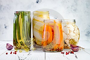 Marinated pickles variety preserving jars. Homemade green beans, squash, carrots, cauliflower pickles. Fermented food