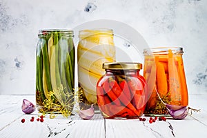 Marinated pickles variety preserving jars. Homemade green beans, squash, radish, carrots, cauliflower pickles. Fermented food