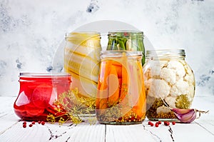 Marinated pickles variety preserving jars. Homemade green beans, squash, radish, carrots, cauliflower pickles. Fermented food