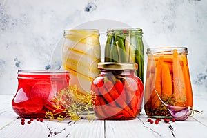 Marinated pickles variety preserving jars. Homemade green beans, squash, radish, carrots, cauliflower pickles. Fermented food