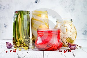 Marinated pickles variety preserving jars. Homemade green beans, squash, radish, cauliflower pickles. Fermented food