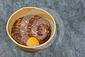 Marinated pork and raw egg for making hot pot