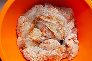 Marinated raw chicken drumsticks ready for grill photo