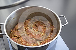 Marinated raw meat in a pan, meat for barbecue photo