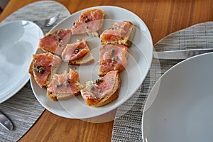 Marinated Salmon Toasts on With Plate With Capers