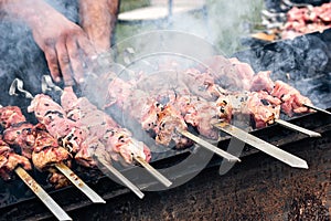 Marinated shashlik preparing on a barbecue grill over charcoal. Roasted stacked meat Shish kebab popular Eastern Europe. Shashlyk