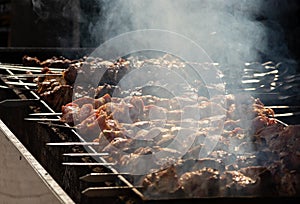 Marinated shashlik preparing on a barbecue grill over charcoal. Shashlik or Shish kebab popular in Eastern Europe