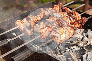 Marinated shashlik preparing on a barbecue grill over charcoal. Shashlik or Shish kebab popular in Eastern Europe