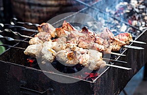 Marinated shashlik preparing on a barbecue grill over charcoal. Shashlik or Shish kebab popular in Eastern Europe. Shashlyk skewe