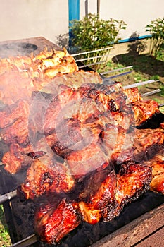 Marinated shashlik preparing on a barbecue grill over charcoal. Shashlik or Shish kebab popular in Europe.