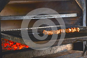 Marinated shashlik preparing on a barbecue grill over charcoal. Shashlyk or Shish kebab. BBQ Grill.