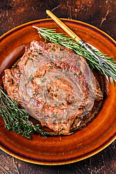 Marinated skirt bavette steaks in bbq sauce on a plata. Dark background. Top view