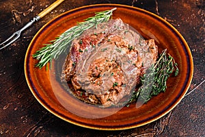 Marinated skirt bavette steaks in bbq sauce on a plata. Dark background. Top view