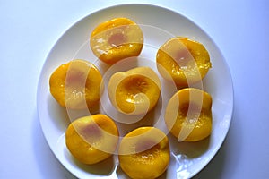 Marinated sliced peaches on a white plate