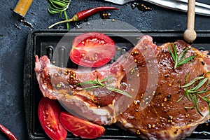 Marinating raw lamb chops with spices, honey and tomato on grill pan, close up