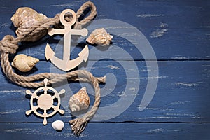 Marine attributes. Rope, frame, wooden anchor and steering wheel on a wooden background. Top vie