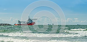A marine auxiliary vessel sailing with other ships at sea